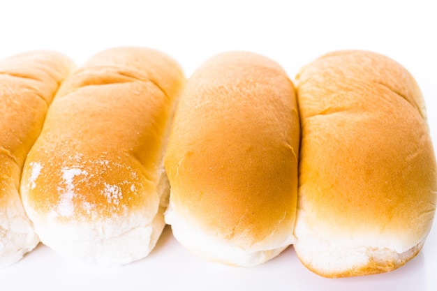 Freshly baked hot dog buns on a white background.