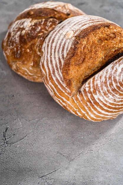 Freshly baked loaf of a wheat sourdough bread with marks from bread proofing basket