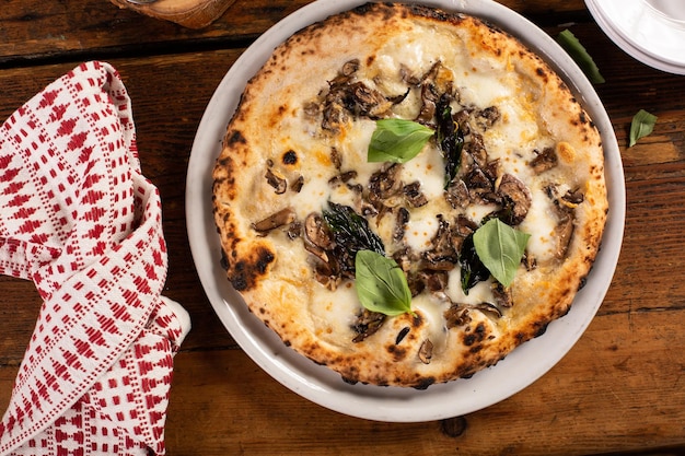 Freshly baked Neapolitan pizza with cheese and mushrooms