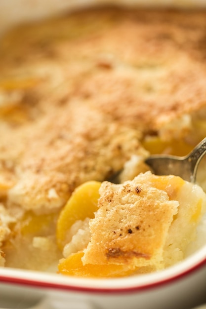Freshly baked peach cobbler made with organic peaches.