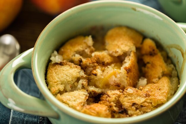 Freshly baked peach cobbler made with organic peaches.