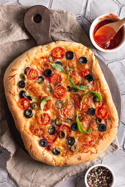 Freshly baked pizza on a wooden board