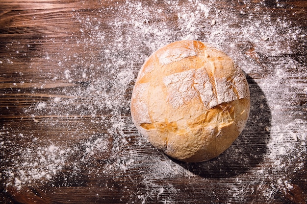 Freshly baked rustic bread on a wooden table