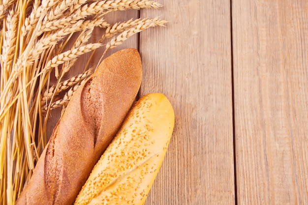 Freshly baked rye bread with cereal and seeds and wheat stems