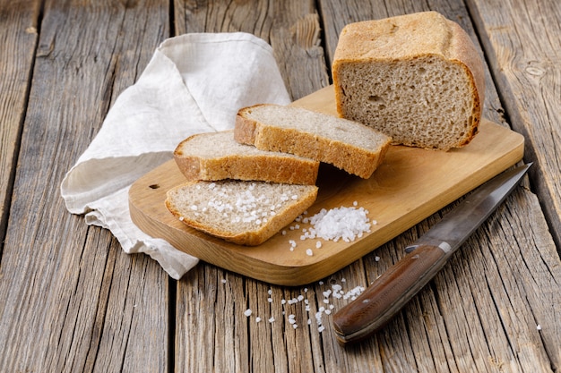 Freshly baked sliced rye bread on wooden cutting board