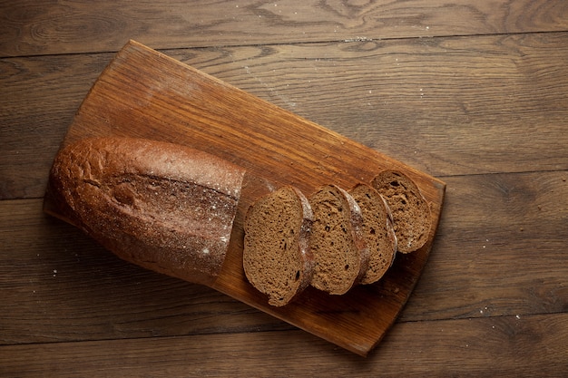 freshly baked sliced rye bread on a wooden cutting board