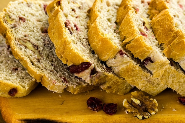 Freshly baked sliced sourdough cranberry nut bread on the table.