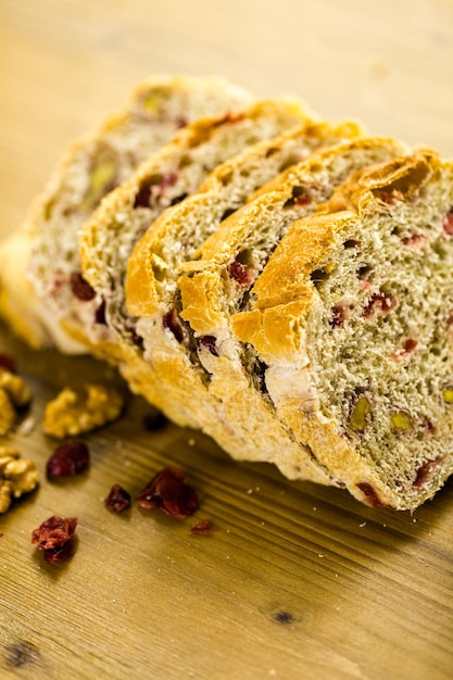 Freshly baked sliced sourdough cranberry nut bread on the table.