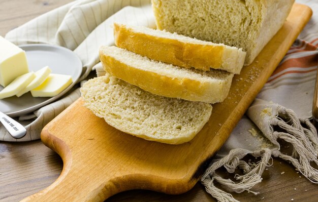 Freshly baked sourdough bread sliced on cutting board.