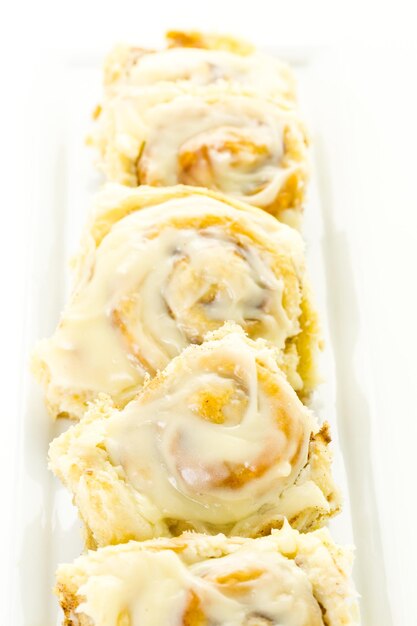 Freshly baked sourdough cinnamon rolls on a white background.