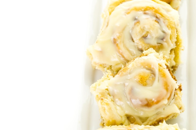 Freshly baked sourdough cinnamon rolls on a white background.