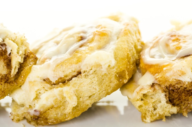 Freshly baked sourdough cinnamon rolls on a white background.