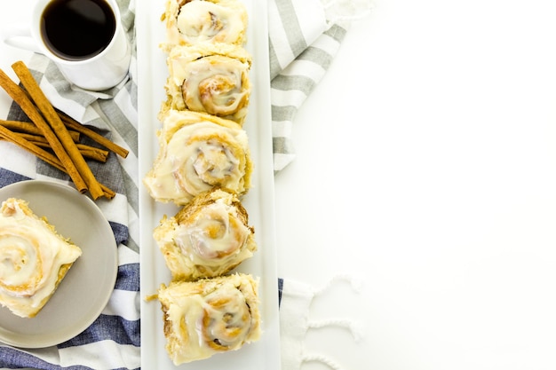 Freshly baked sourdough cinnamon rolls on a white background.