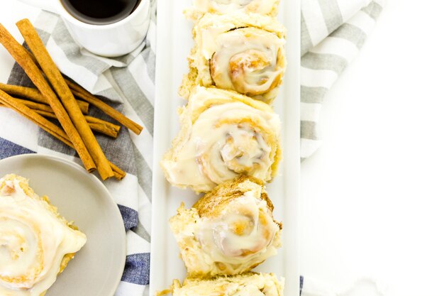 Freshly baked sourdough cinnamon rolls on a white background.