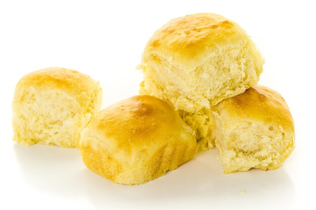 Freshly baked sourdough dinner rolls on a white background.