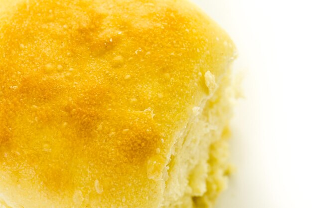 Freshly baked sourdough dinner rolls on a white background.