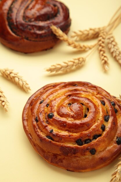 Freshly baked sweet bun with chocolate on beige background top view