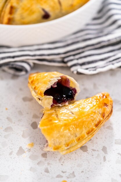 Freshly baked sweet empanadas with blueberries on the kitchen counter