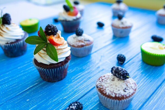 Freshly baked sweet muffins on a blue background. sweet pastries, recipes, cooking