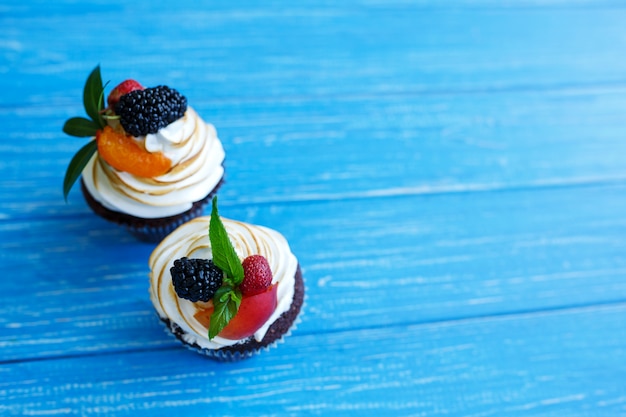 Freshly baked sweet muffins on a blue table. Sweet pastries, recipes, cooking