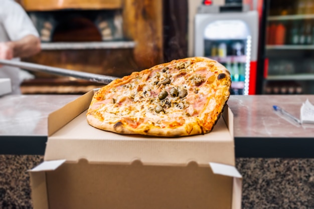 Freshly baked take away pizza.