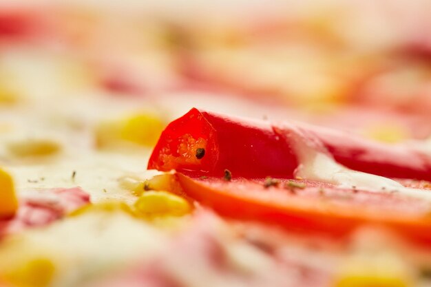 Freshly baked tasty pepperoni pizza with salami mozzarella cheese corn and pepper served on wooden background with tomatoes sauce and herbs Food delivery concept Restaurant menu