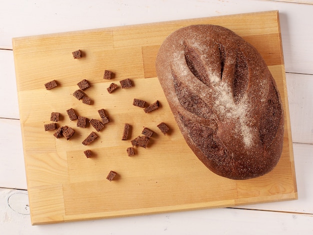 Freshly baked traditional bread and crackers on cutting board