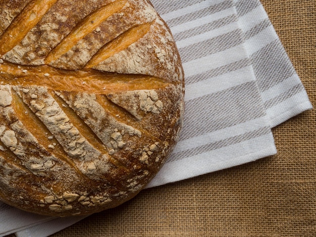 Freshly baked traditional bread with beautiful pattern on wooden table