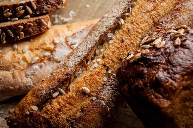 Freshly baked traditional bread with sunflower seeds on wooden table fresh baguette with salt