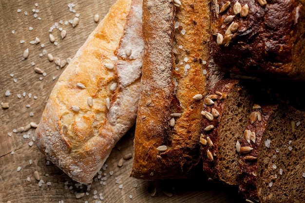 Freshly baked traditional bread with sunflower seeds on wooden table fresh baguette with salt