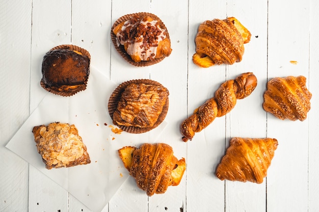 Freshly baked traditional bread on wooden table ,baked croissants in a bakery