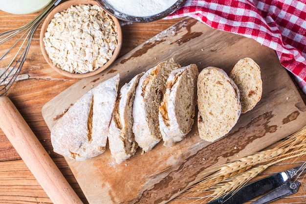 Freshly baked traditional bread on wooden table Oatmeal Bread