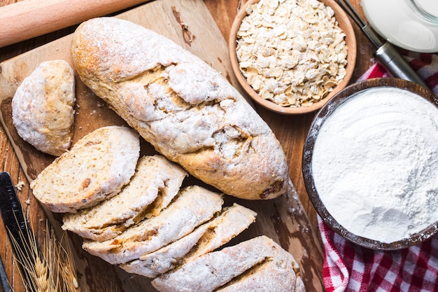 Freshly baked traditional bread on wooden table Oatmeal Bread