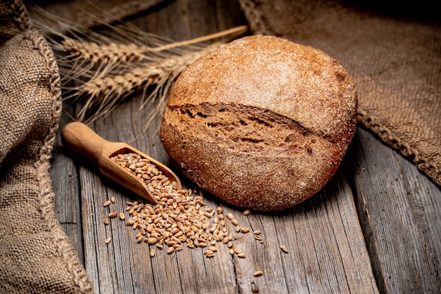 Freshly baked traditional bread on wooden table