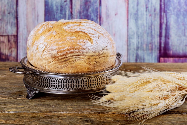 Freshly baked traditional bread on wooden table