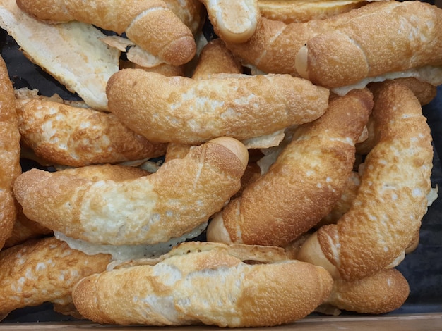 Freshly baked white Czech rohlik rolls with melted cheese in bakery or grocery store