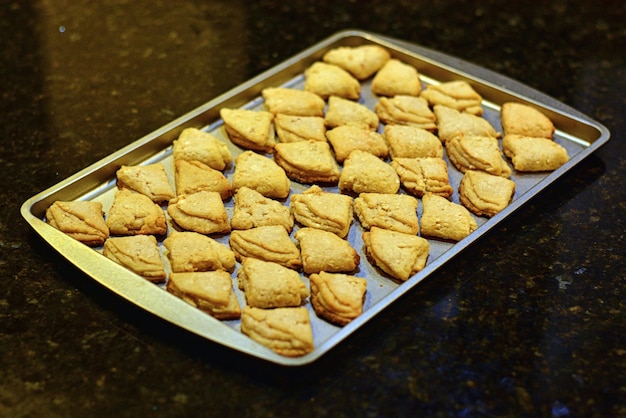 Freshly baked yellow cookies on a baking sheet