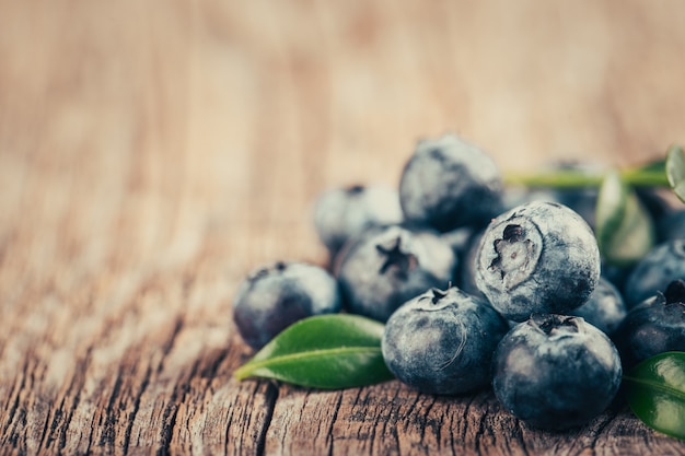 Freshly blueberries on wooden background.