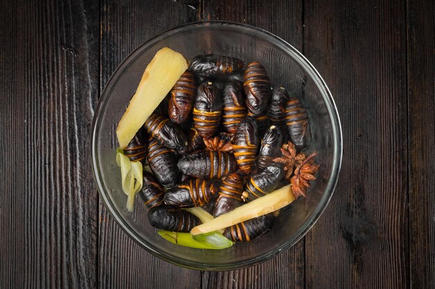 Freshly boiled chrysalis against a dark background