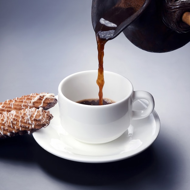 Freshly brewed black coffee from the turks poured in a white Cup