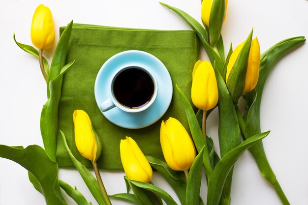 Freshly brewed coffee and yellow tulips