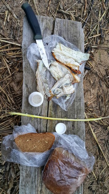 Freshly caught fish caught on a fishing with bread and salt on a wooden board