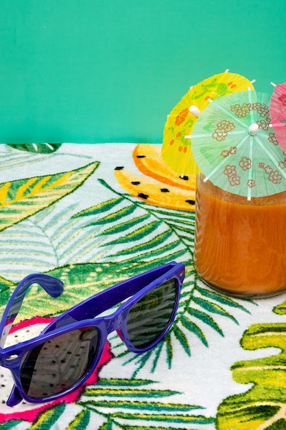 Freshly cut watermelon with a small umbrella, a glass of gazpacho and sunglasses.