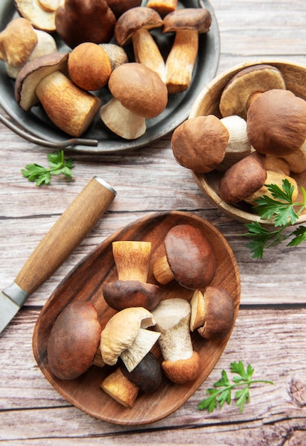 freshly harvested mushrooms arranged on a wooden table with a knife