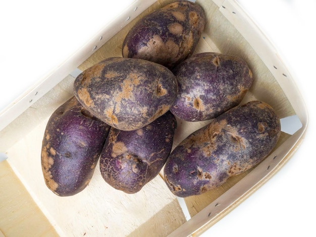 Freshly harvested organic sweet potatoes in wooden box Sweet potato contain insoluble fiber that can help relieve constipation