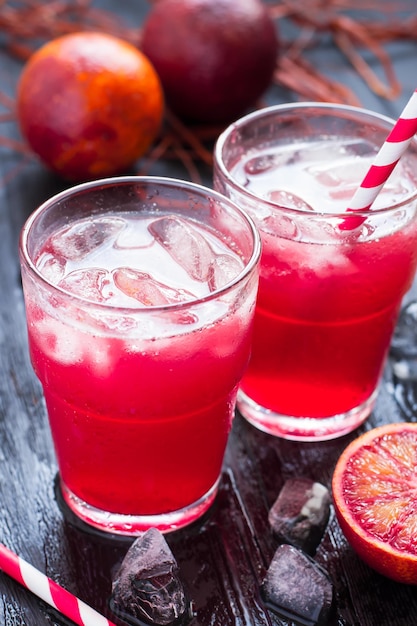 Freshly juice from blood oranges with ice.