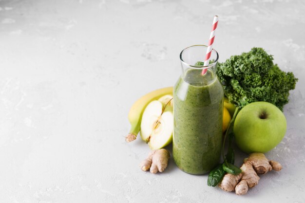 Freshly made bottle of green smoothie, close-up.