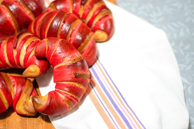 Freshly made Croissants and Cornettos pastries exposed on white cloth background