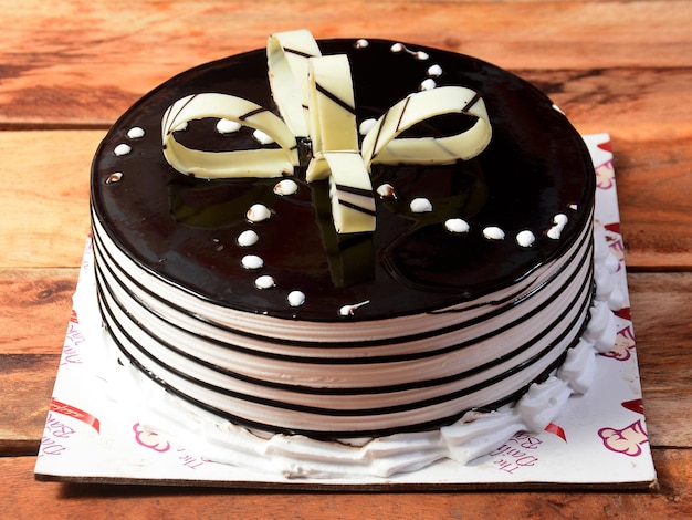 Freshly made delicious chocolate cake on wooden table