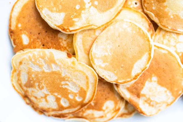 Photo freshly made small pancakes on a kefir base.